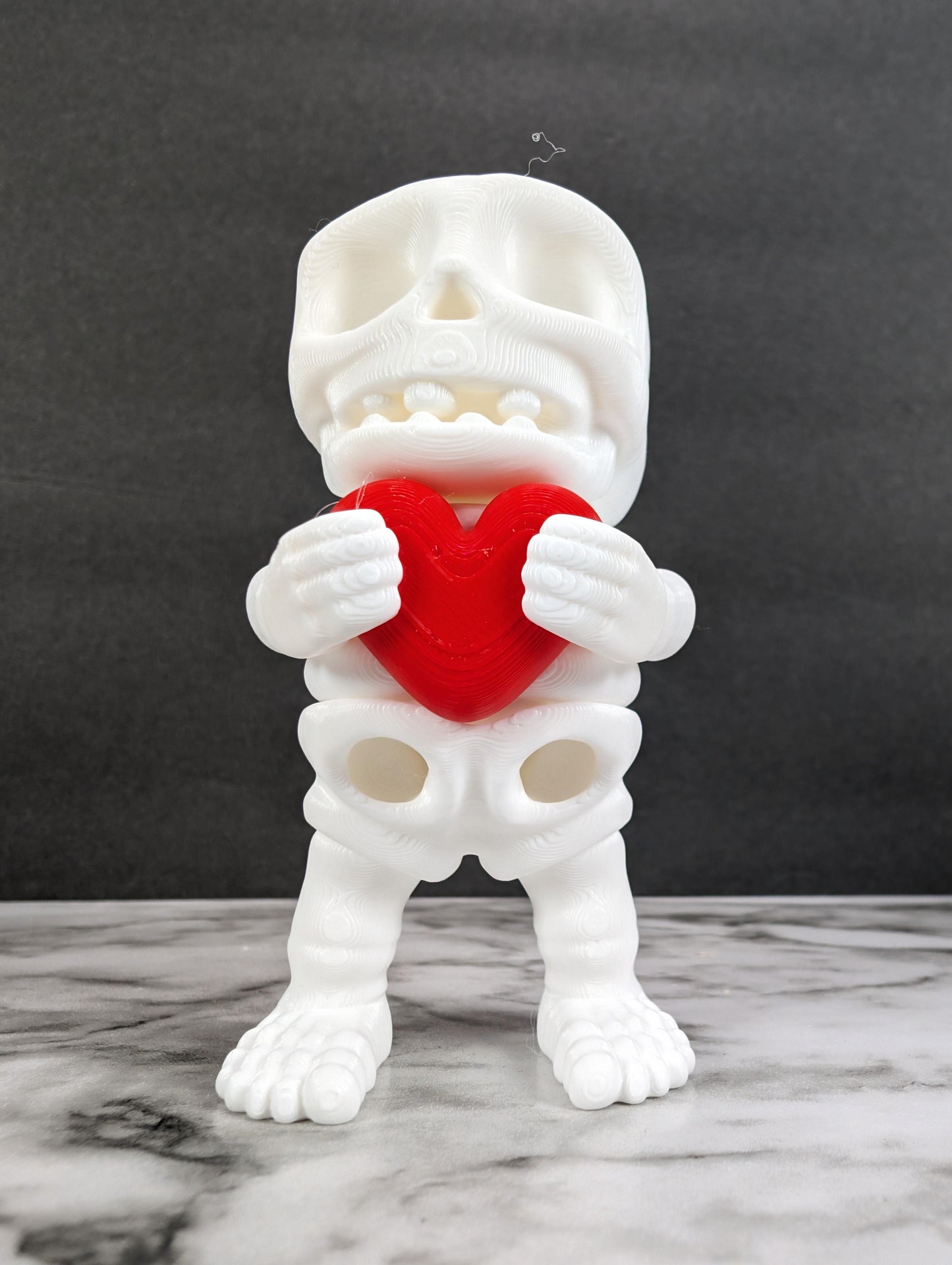 3D Printed Flexi Skeleton Holding a Heart - Fidget Sensory - Valentines Day by Zou3D