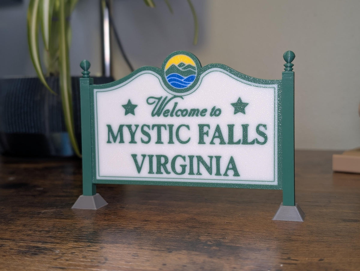 Mystic Falls Welcome Sign 3D printed in green, white, and blue – front view on desk