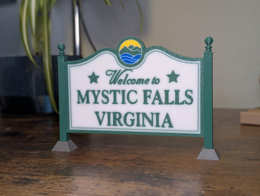 Mystic Falls Welcome Sign 3D printed in green, white, and blue – front view on desk